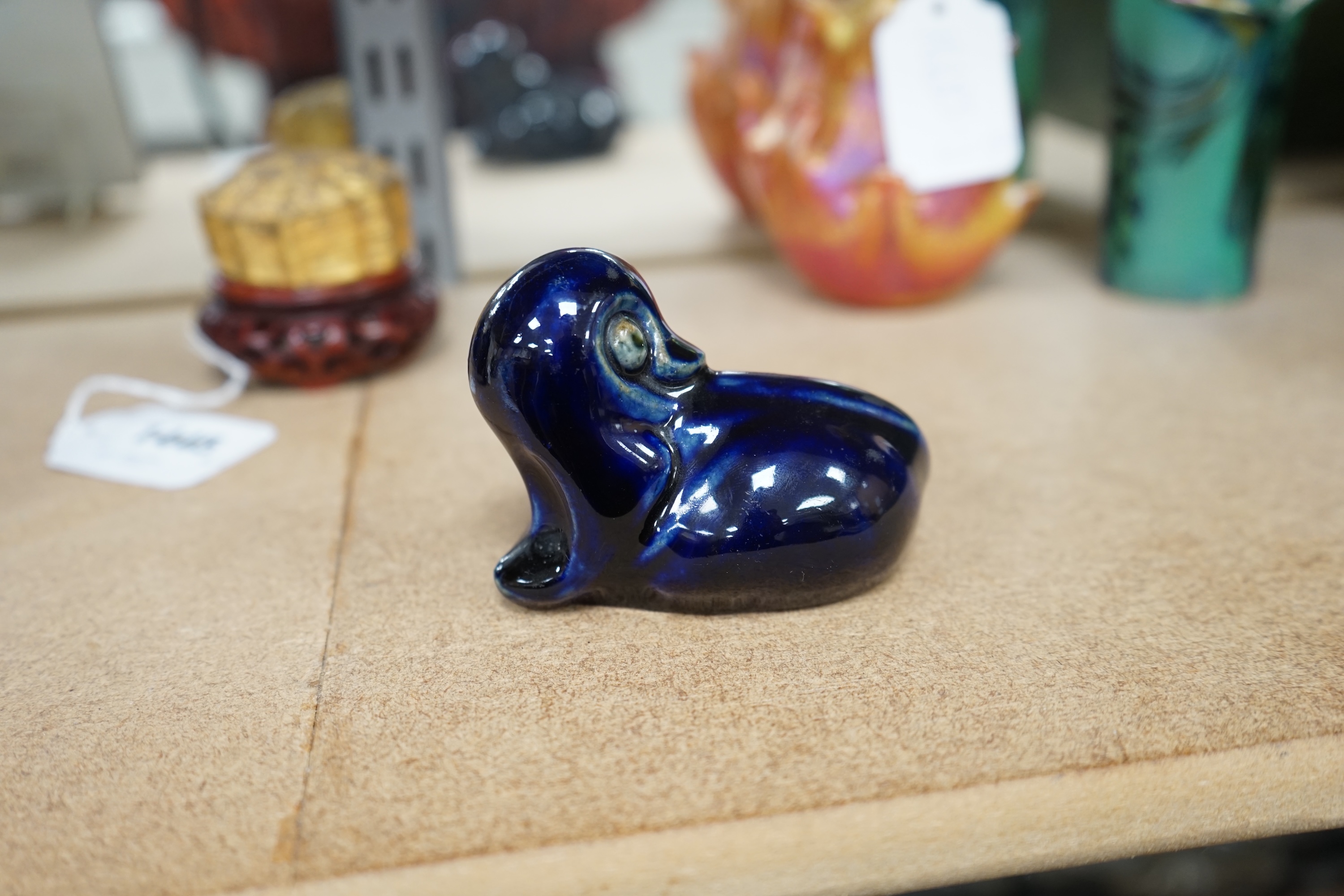 A Royal Doulton stoneware grotesque blue glazed 'duck' by Mark V. Marshall, 9cm wide. Condition - good